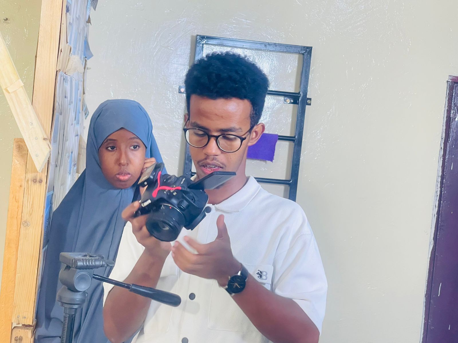 Participants reviewing footage on a camera during production