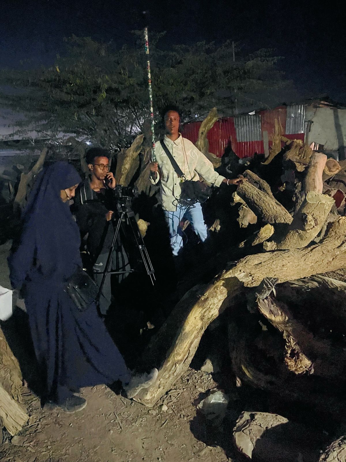 A crew filming at night on location