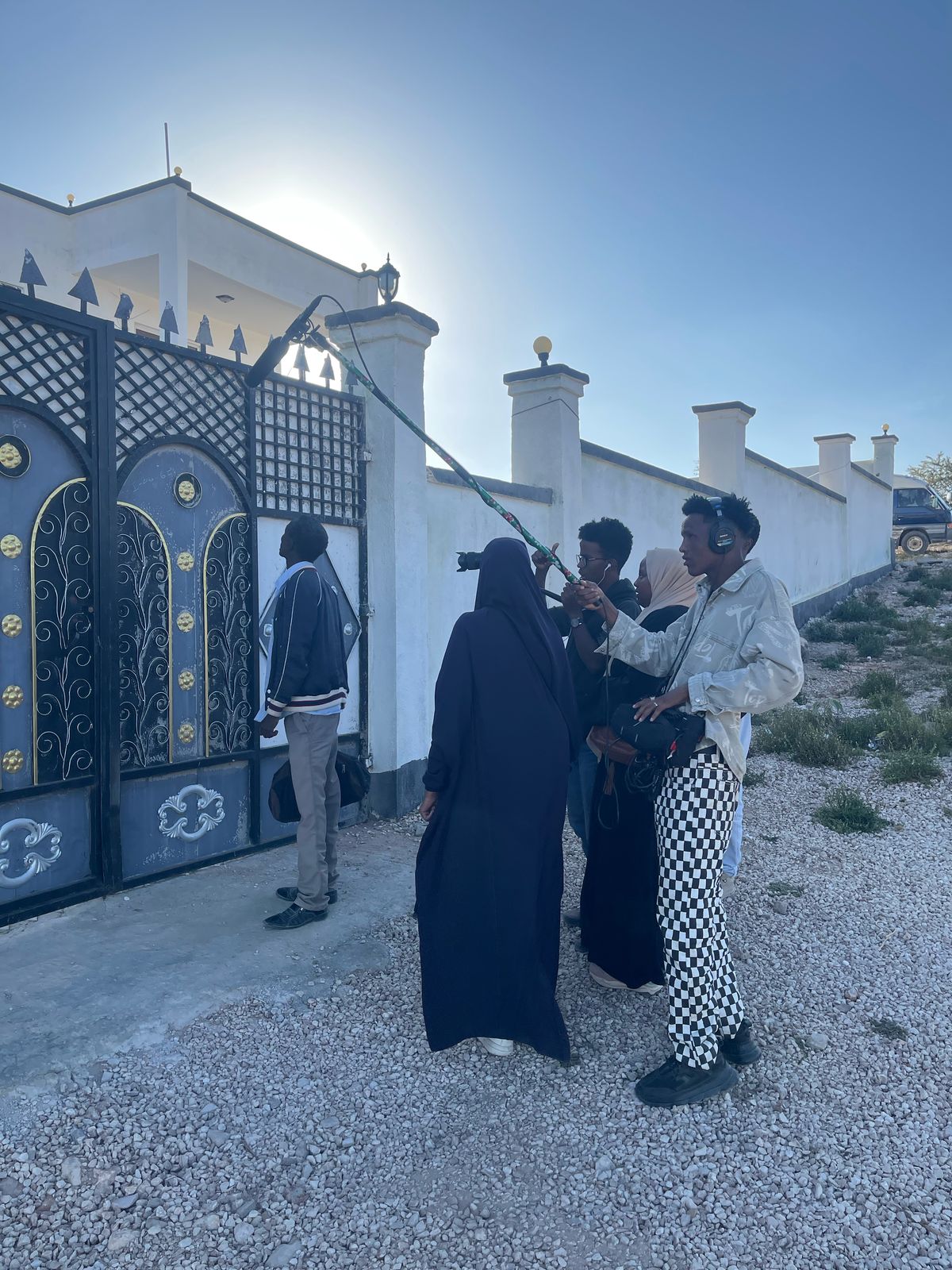 A crew filming at a compound gate in Somaliland
